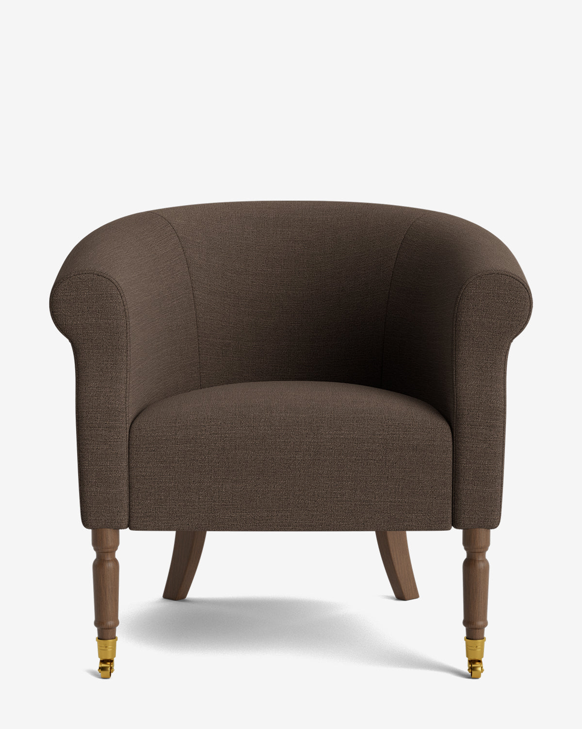The Clemence Lounge Chair is a brown upholstered lounge chair with curved armrests, wooden legs, and small brass caster wheels on the front legs, shown from the front against a white background by McGee & Co.