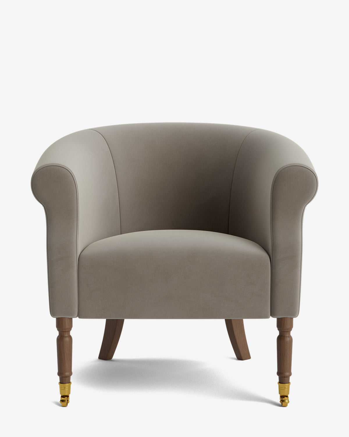 The Clemence Lounge Chair features taupe velvet upholstery, rounded arms, a curved backrest, wooden front legs with brass castor wheels, and slightly splayed back legs for a classic designer look, by McGee & Co.
