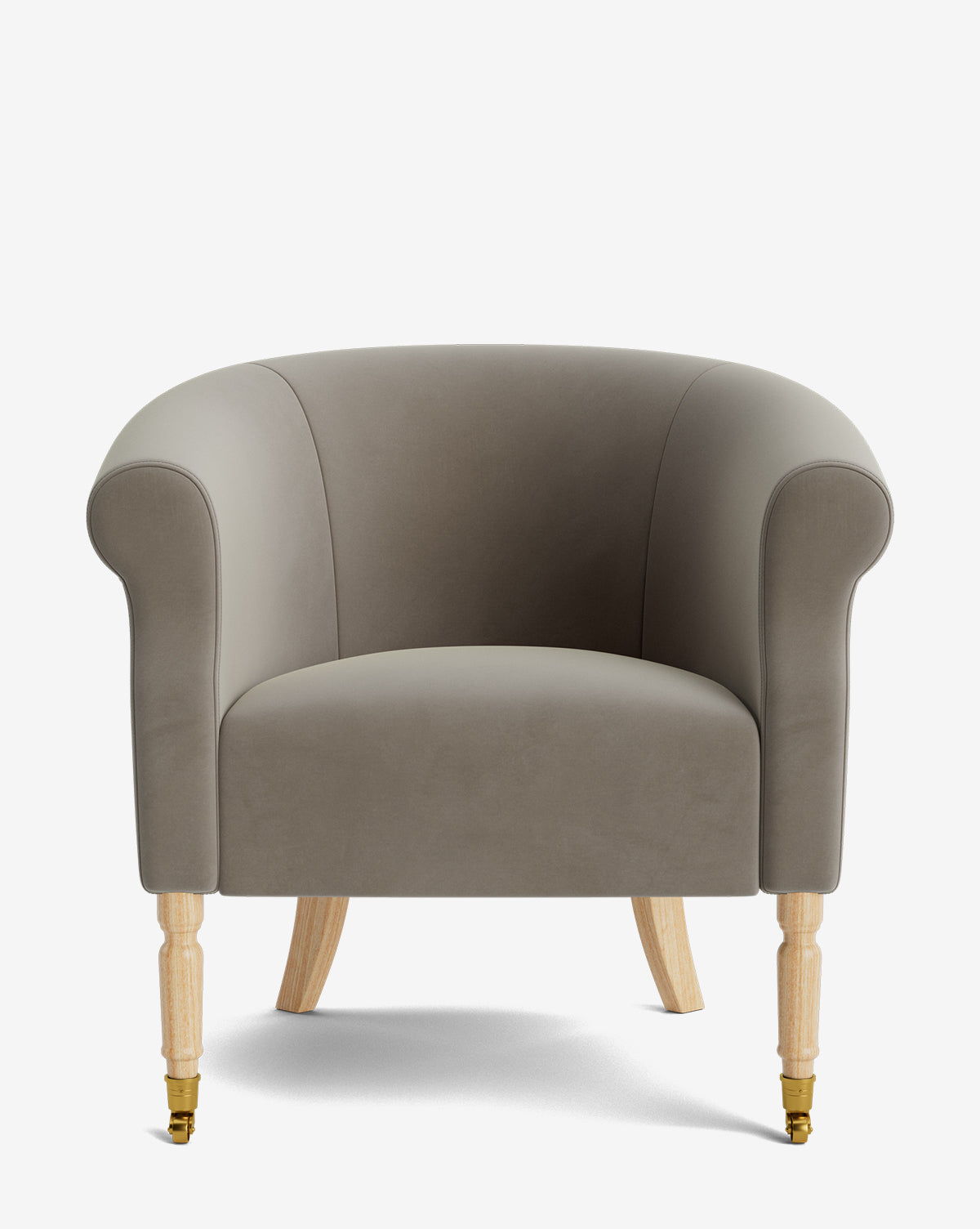 The Clemence Lounge Chair features gray designer fabric upholstery, wooden legs with brass casters on the front, and is shown against a white background by McGee & Co.