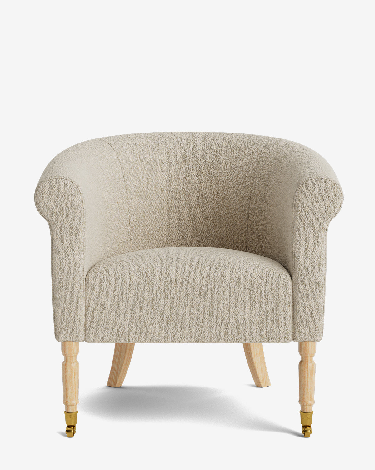 The Clemence Lounge Chair features beige textured designer fabric, a rounded back, rolled arms, light wooden legs, and small brass castors on the front legs, shown against a white background by McGee & Co.