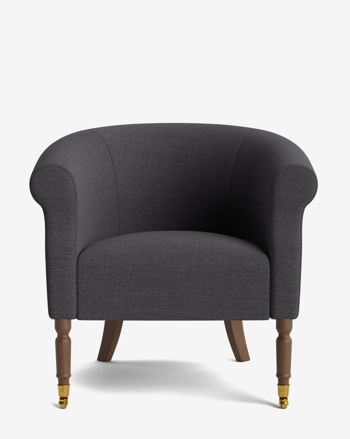 The Clemence Lounge Chair is a dark gray classic living room chair with designer fabric, rounded arms, and wooden legs—front legs feature brass casters, and the gently curved back legs, by McGee & Co.