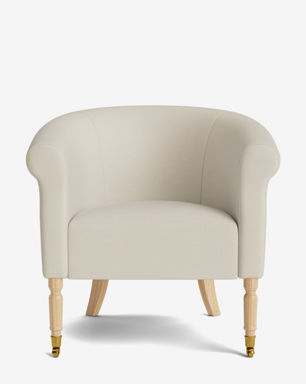 The Clemence Lounge Chair features light beige upholstery, rounded arms and back, wooden legs, and brass castor wheels on the front legs—a classic choice for your living room, shown against a white background, by McGee & Co.