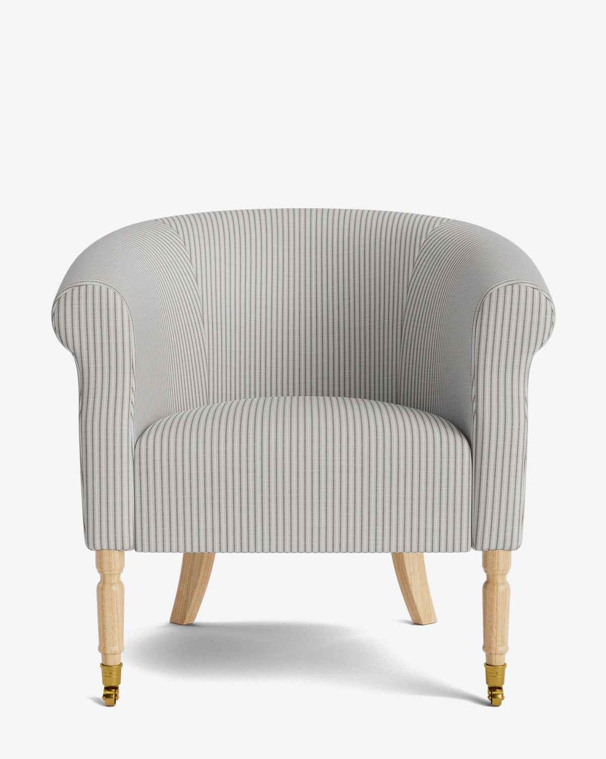 The Clemence Lounge Chair features light gray and white vertical stripes, rounded arms, designer fabric upholstery, and wooden legs with brass caster wheels, by McGee & Co. Photographed against a plain white background.