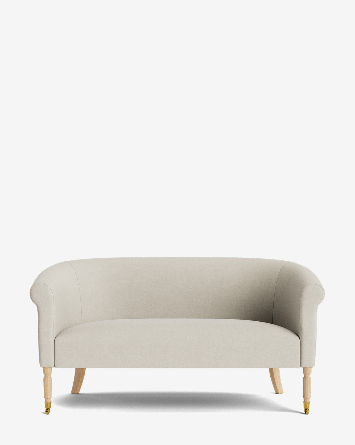 The Clemence Settee 60 features a modern, light beige designer fabric, curved armrests, wooden legs, and brass casters on the front legs—an elegant piece to elevate any living space, by McGee & Co.