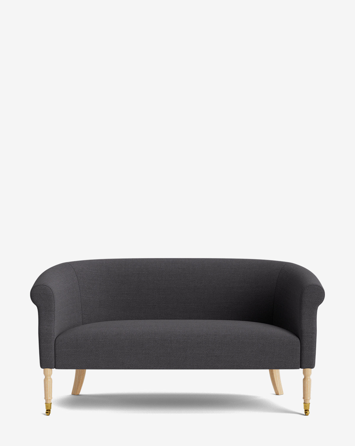 The Clemence Settee 60 features designer dark gray upholstery, curved arms, and wooden legs with brass castors on the front—an elegant piece that’s perfect for enhancing any living space, by McGee & Co.