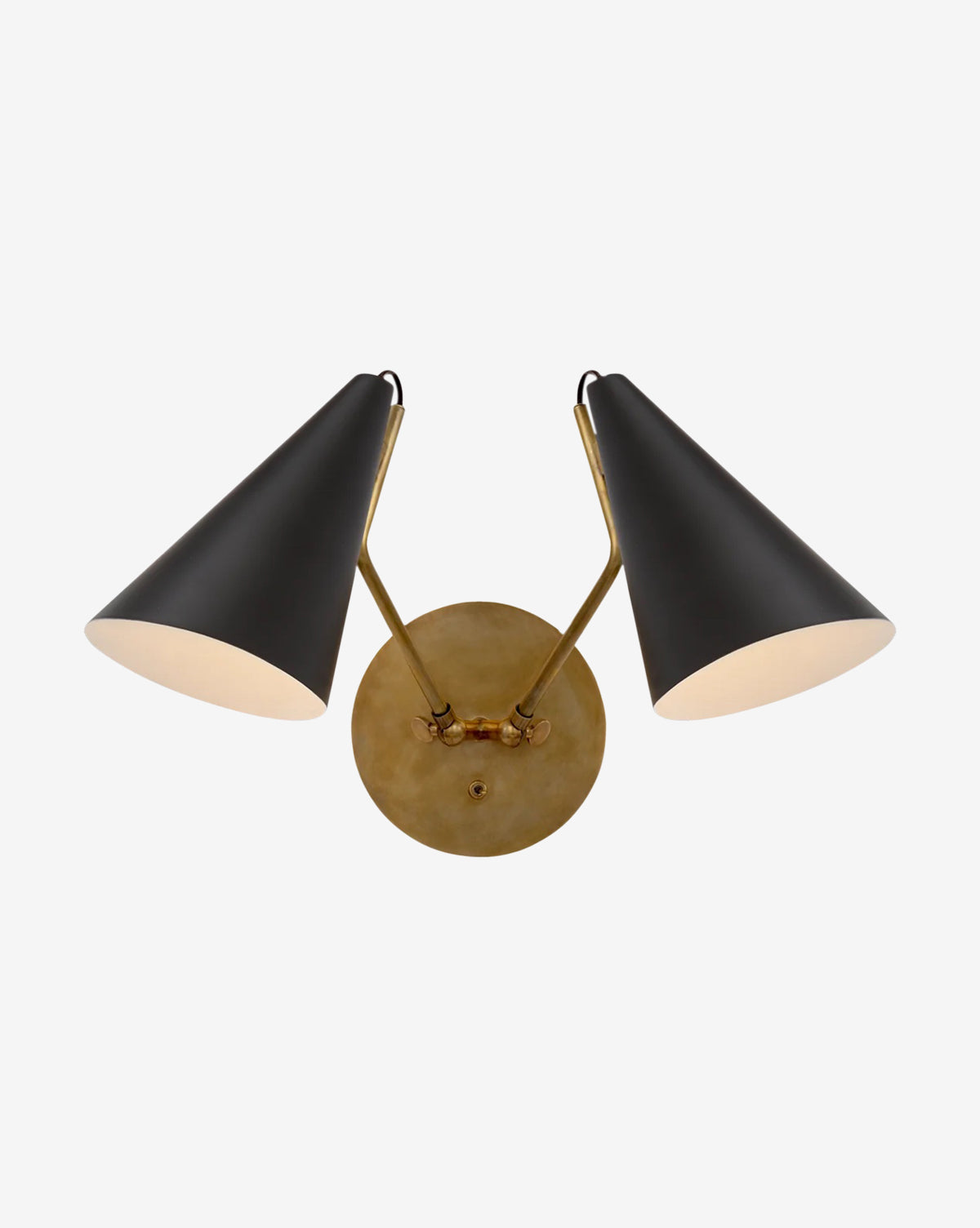 The Clemente Double Sconce by Visual Comfort & Co. Signature features two black, cone-shaped shades angled outward on a round, hand-rubbed brass base, offering an elegant lighting solution for any room by McGee & Co.