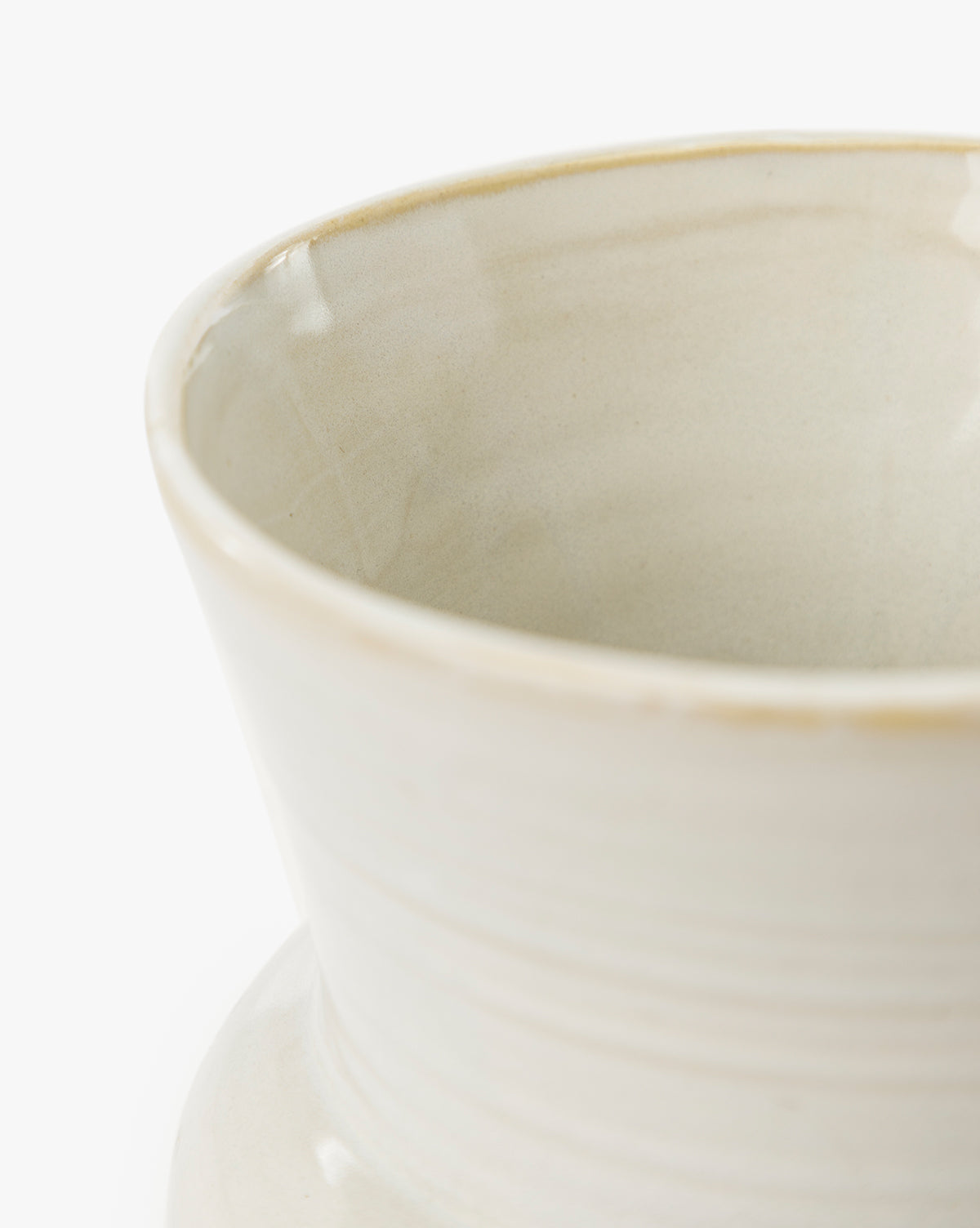 A close-up of the upper portion of the cream-colored Colchester Planter, crafted from high-quality ceramic with a glossy finish and subtle horizontal lines—ideal for enhancing your home decor, by McGee & Co.