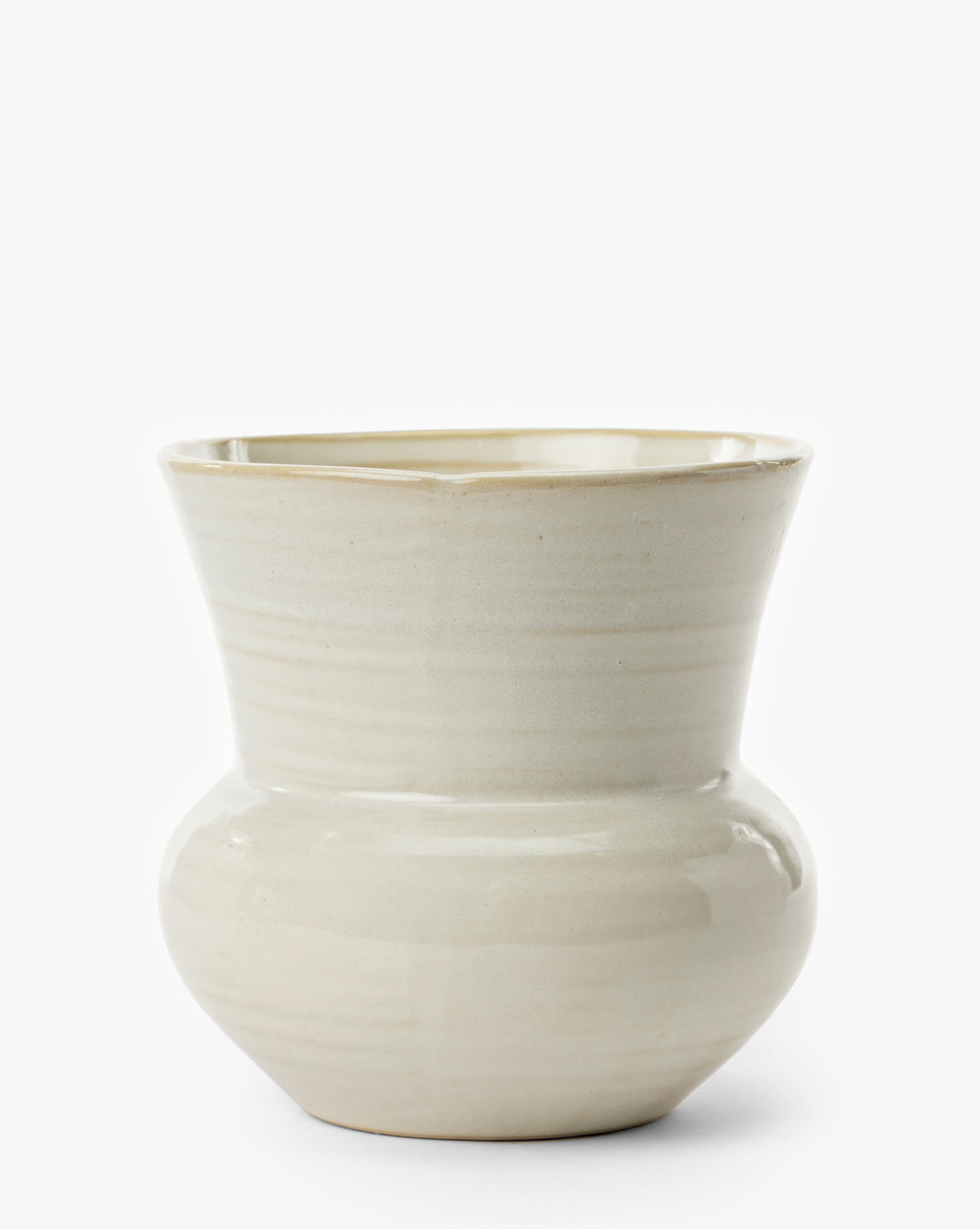 The Colchester Planter is a cream-colored ceramic piece with a wide rounded base, flared tapered rim, glossy finish, and subtle horizontal lines—an ideal choice for modern home décor, by McGee & Co.