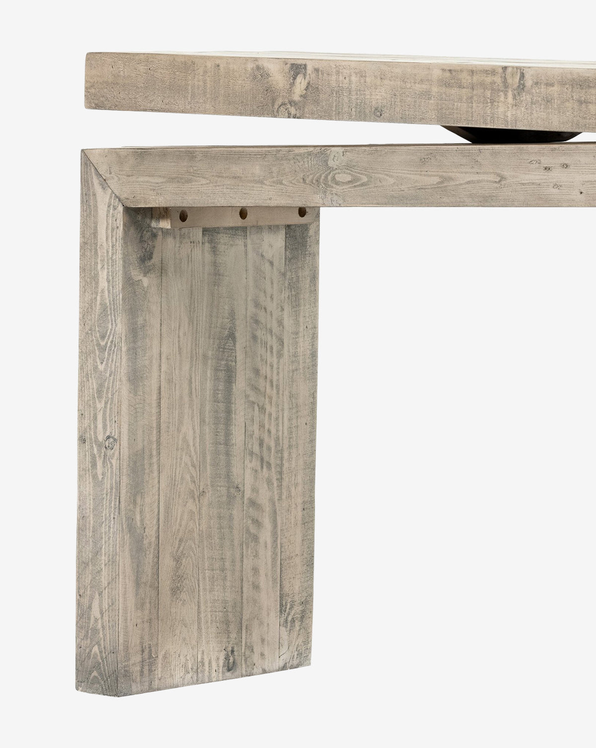 Close-up of the Colter Console Table, a modern entryway piece made from reclaimed wood with a rustic light gray finish, showcasing its thick rectangular leg and tabletop edge against a white background, by McGee & Co.