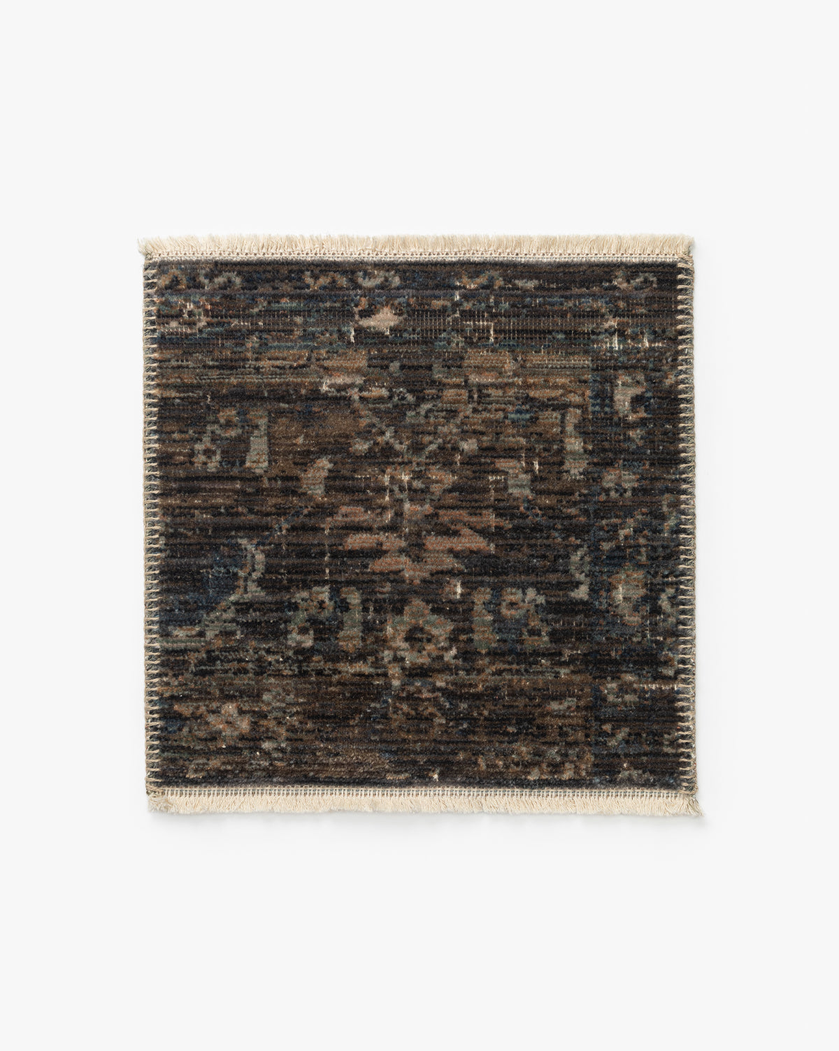 The Conley Lagoon Rug Swatch is a rectangular sample with a dark, distressed pattern in brown, black, and blue, showcasing an intricate motif and beige fringe on the short edges, shown on a white background by McGee & Co.
