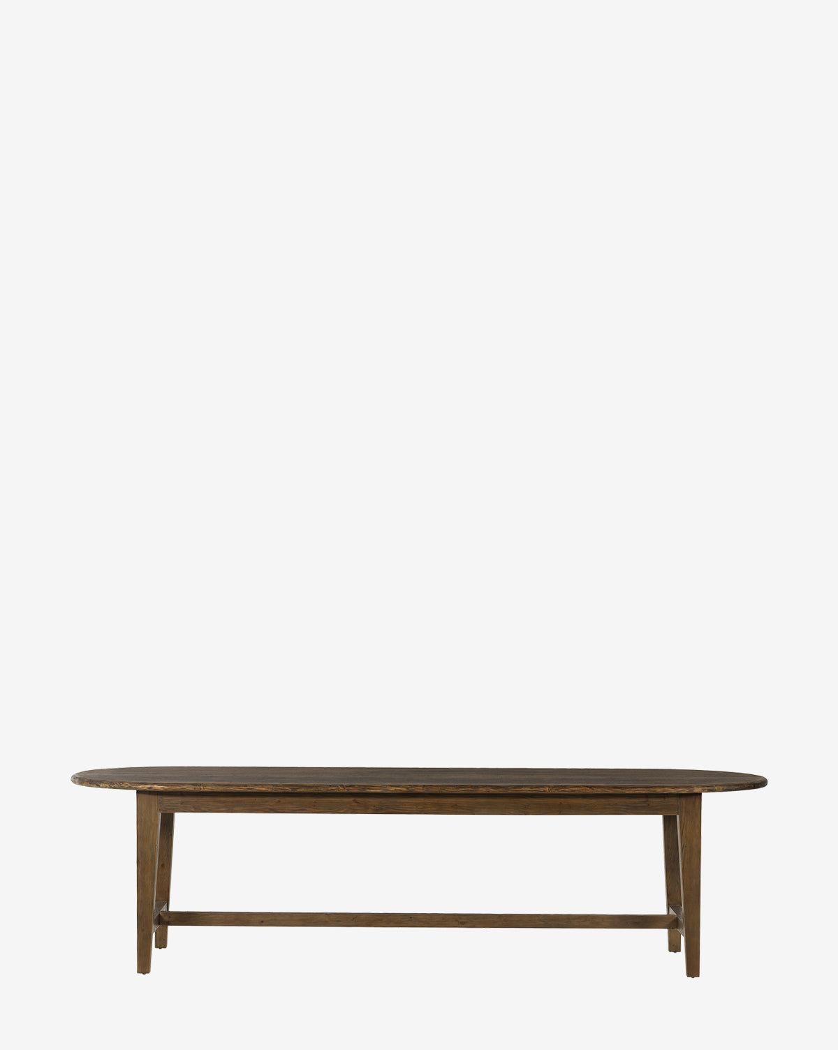 The Constance Dining Table is a simple, dark brown solid pine table with a rectangular top, rounded edges, and four straight legs with a horizontal support bar, shown against a plain white background by McGee & Co.