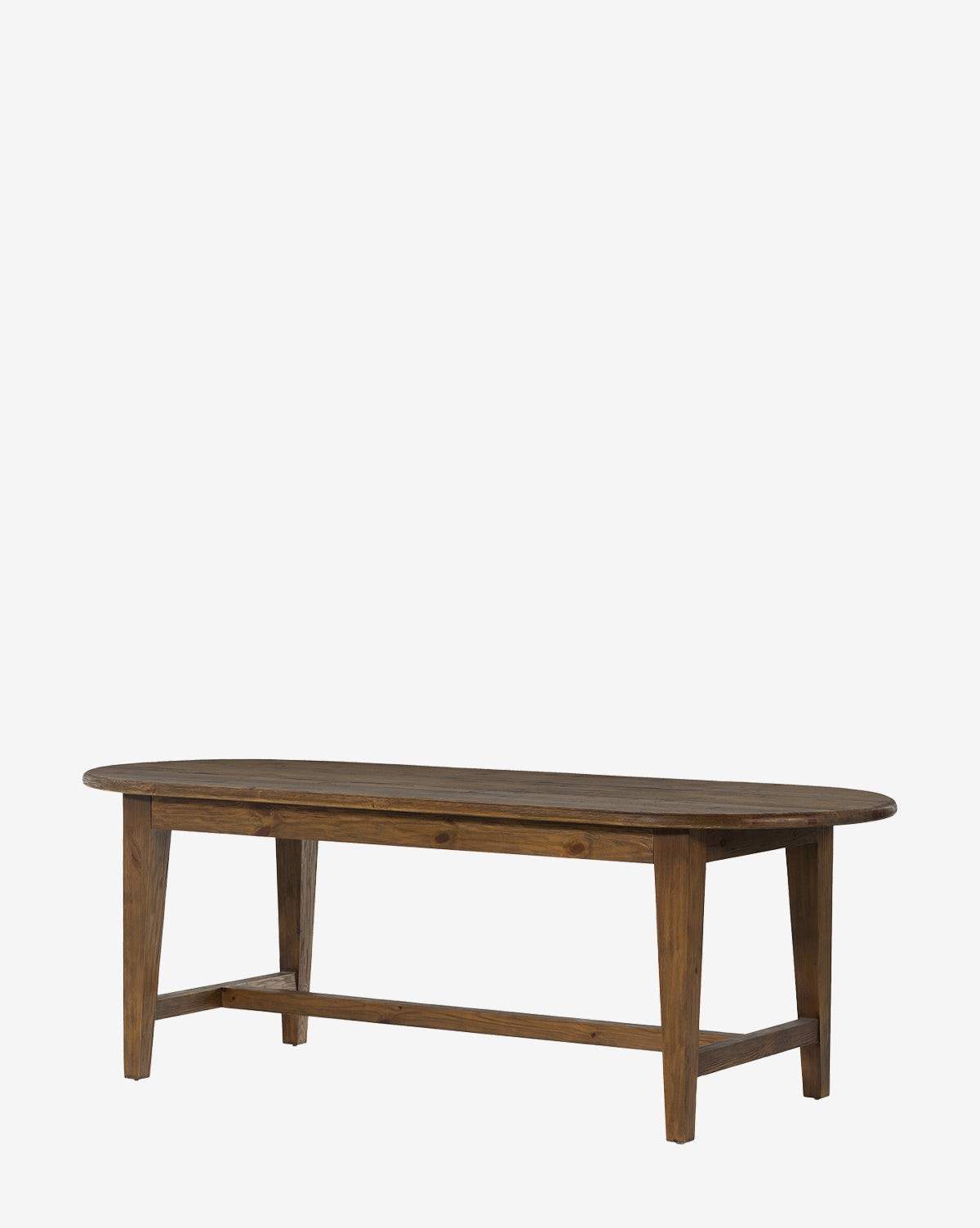 The Constance Dining Table is a solid pine, oval wooden table with four straight legs and a crossbar support, offering modern farmhouse style to any setting, by McGee & Co.