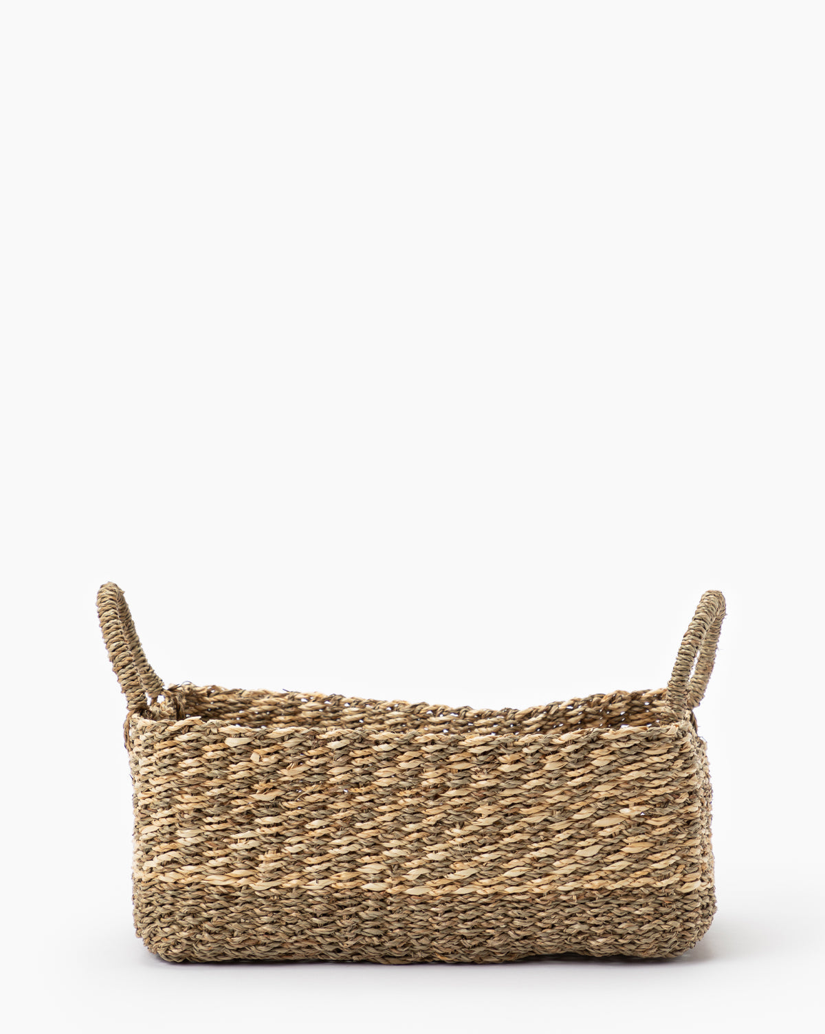 The Cordova Basket is a rectangular, natural-colored woven grass basket with two raised handles at each end, ideal for stylish storage. It is displayed on a plain white background.