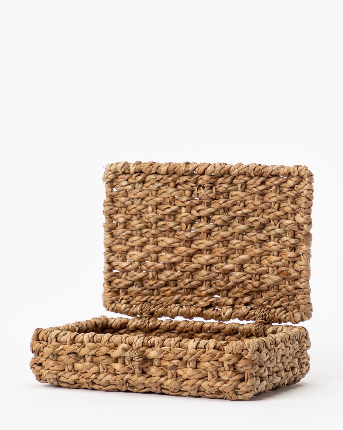 The Corinne Woven Box, a rectangular seagrass box with a hinged lid crafted from natural fibers, is open and empty against a plain white background.