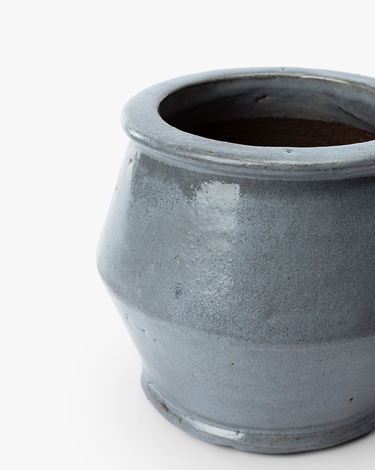 The Corsica Pot is a round ceramic stoneware planter in grayish-blue, featuring a wide opening and slightly flared rim, displayed against a white background, by McGee & Co.