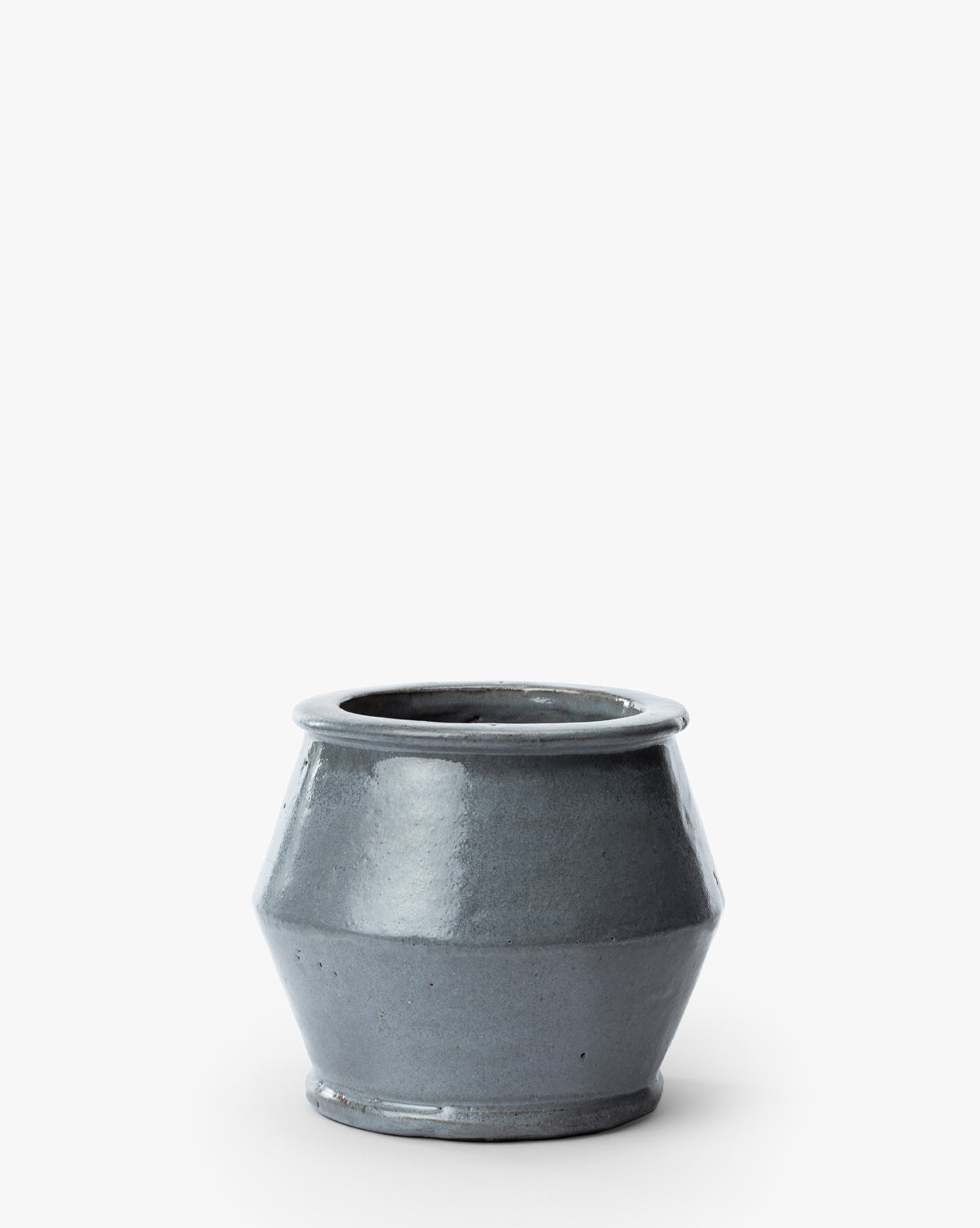 The Corsica Pot is a simple ceramic stoneware planter in gray, featuring a wide opening and gently flared sides, shown against a white background, by McGee & Co.