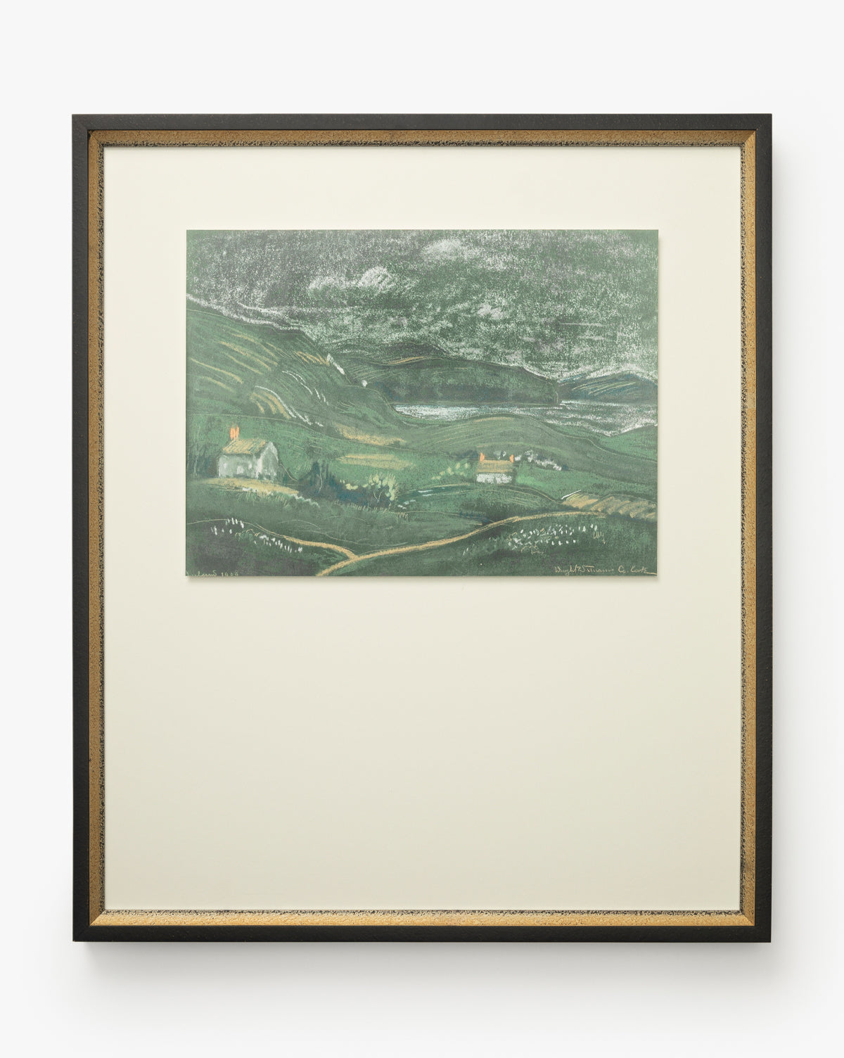 Country Dusk is a framed giclee print showing a serene green countryside with rolling hills, fields, and small houses. It comes in a black and gold frame with a wide off-white mat that complements the artwork beautifully, by McGee & Co.
