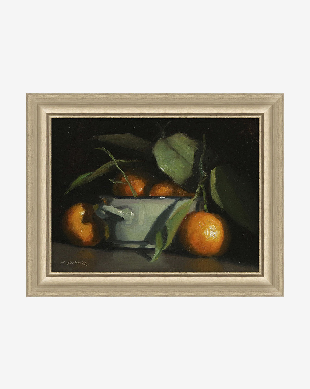 The Oranges Still Life is a framed painting featuring a white bowl with oranges and green leaves on a dark background. Some oranges are in the bowl while others are beside it, making striking canvas wall art for any space.