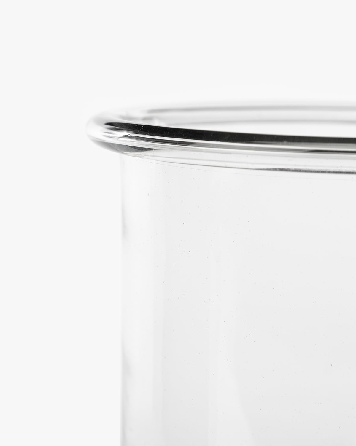 Close-up of the rim and upper side of the clear glass Cyrus Hurricane candle holder against a white background, perfect for elegant home decor, by McGee & Co.