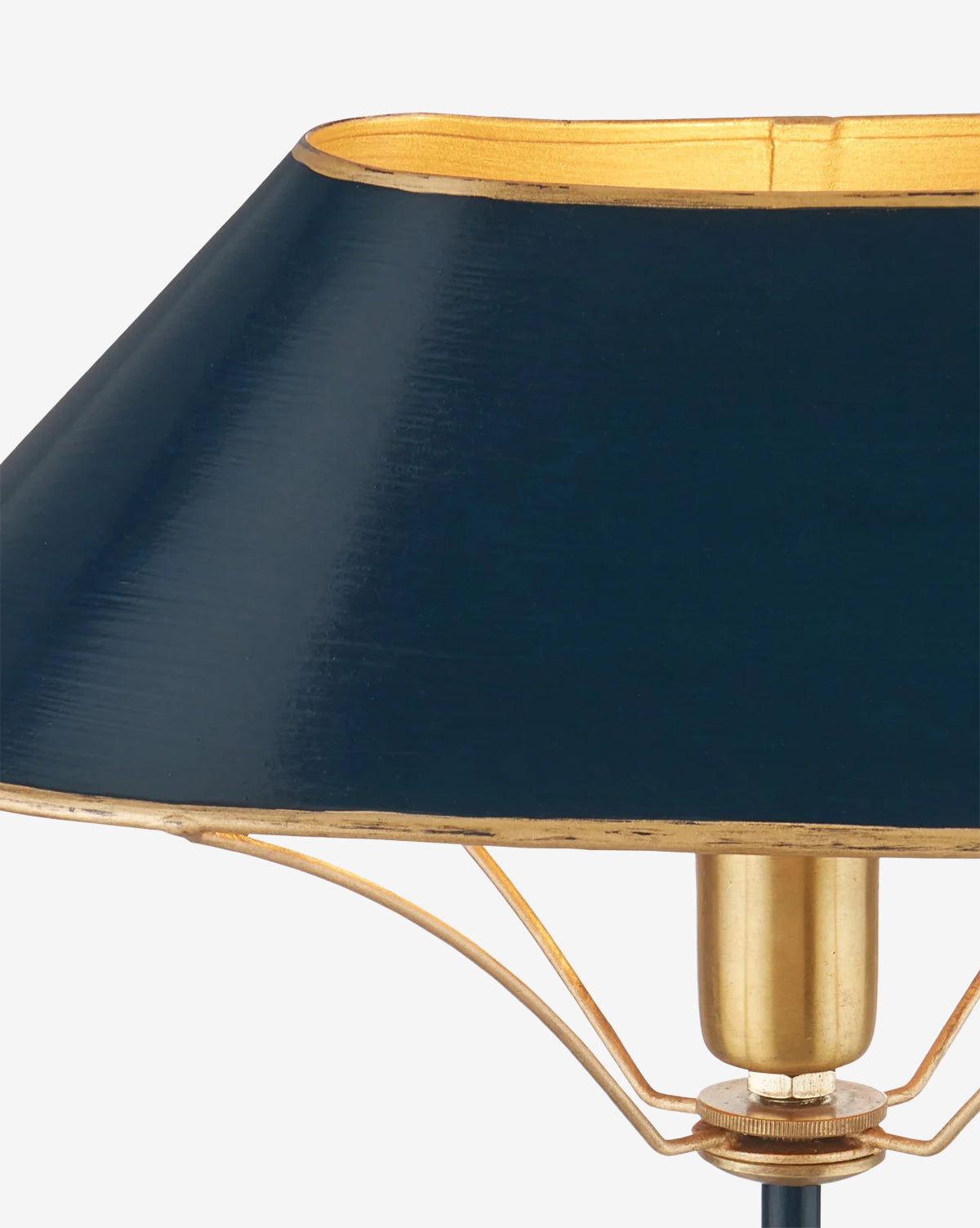 Close-up of the Daphne Navy Table Lamp featuring a dark blue, slightly conical lampshade and a brass fixture, set against a plain white background, by McGee & Co.