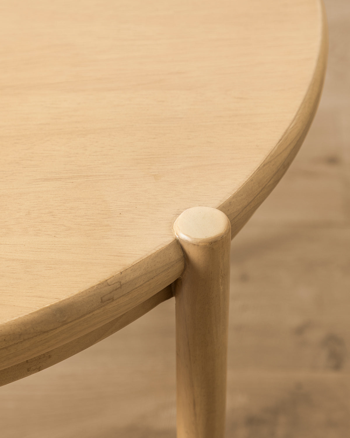 Close-up of the Darcy Kids Table, a round light wood table crafted from white oak, highlighting its smooth tabletop edge and rounded leg with a natural wood grain finish, by McGee & Co.