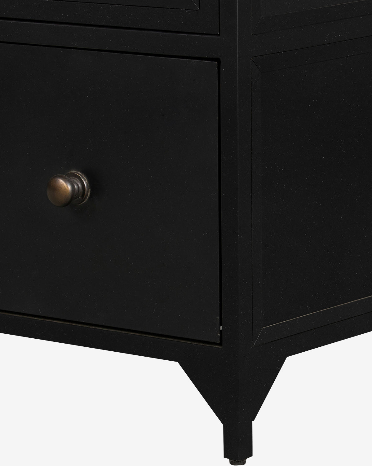 Close-up of the Deano Cabinet’s lower corner, showcasing its black finish, metallic round knob, and angled legs against a white background, by McGee & Co.