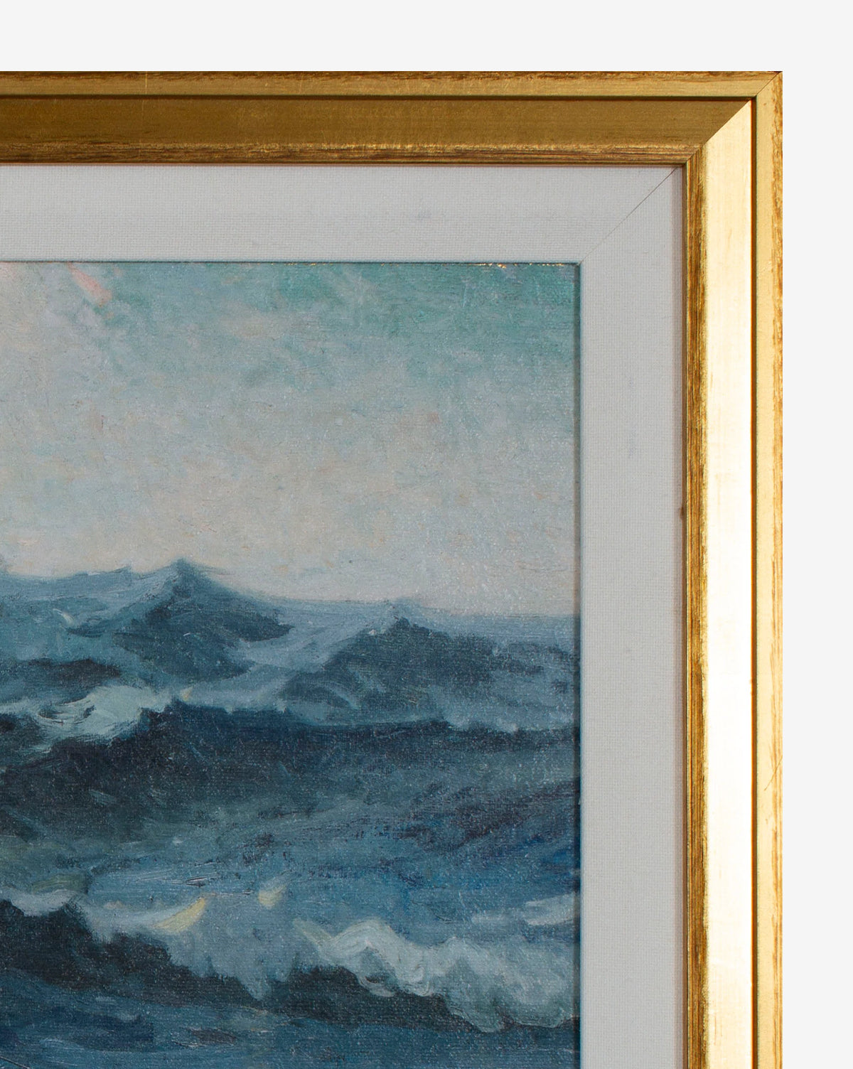 A close-up of Deep Blue Waves, a gallery-quality framed artwork, shows part of the stormy blue ocean painting beneath a cloudy sky and its elegant gold frame.