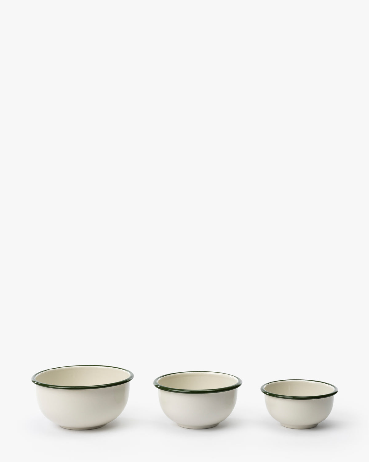 The Delia Bowls (Set of 3) feature vintage-inspired green rims and durable white enamel. Arranged from largest to smallest, they bring timeless charm to your kitchen—perfect for daily use or as a display piece by McGee & Co.