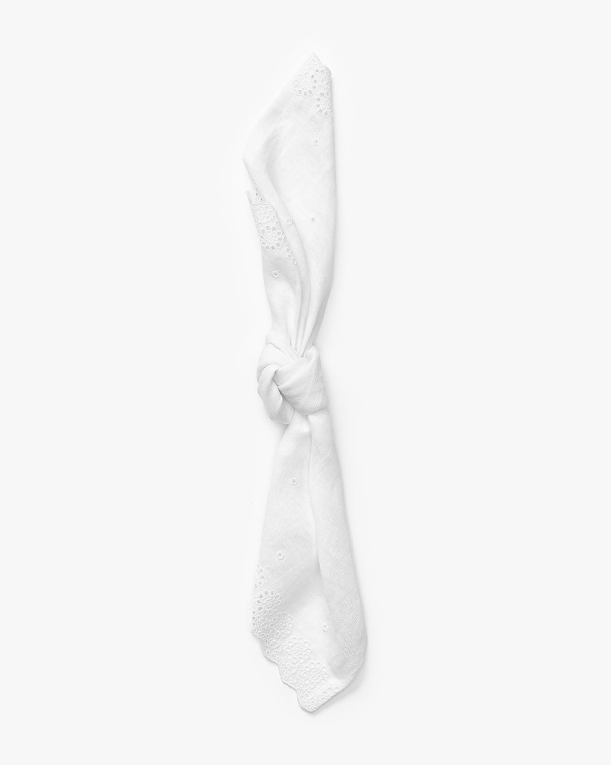 The McGee & Co. x Loeffler Randall Delilah Broderie Napkin, shown neatly knotted at the center, features a delicate broderie border and is displayed against a plain white background by McGee & Co.