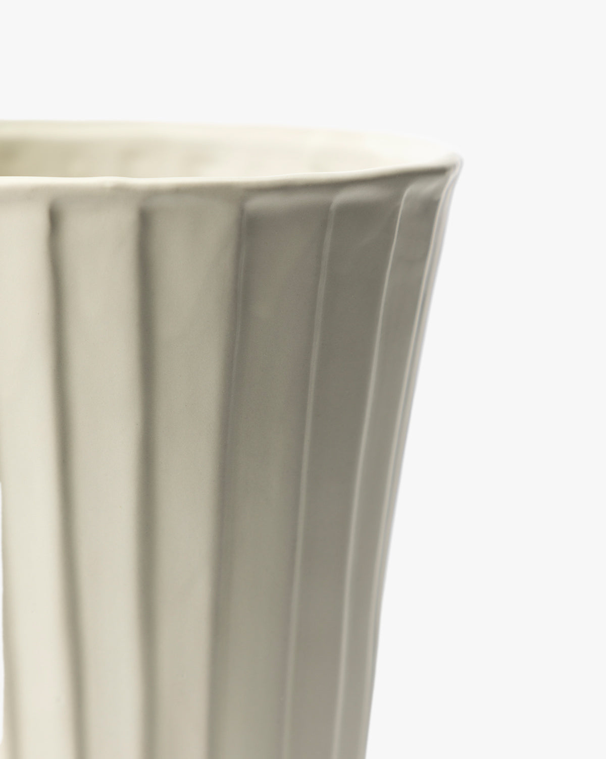 Close-up of the Delphi Footed Vase, featuring a white stoneware body with fluted texture and glossy finish. The image shows only the upper portion and one side, set against a plain white background, by McGee & Co.