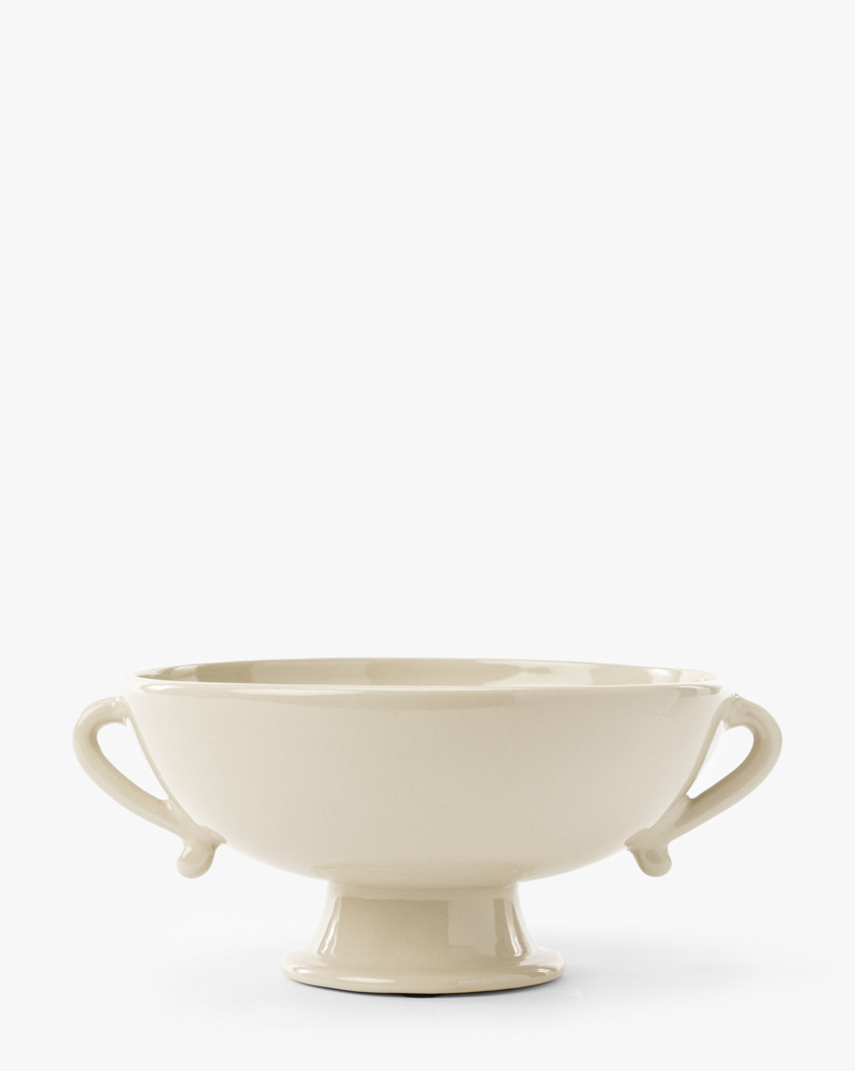 The Delphine Footed Bowl is a cream-colored ceramic piece featuring two curved side handles and a pedestal base, displayed against a plain white background, by McGee & Co.