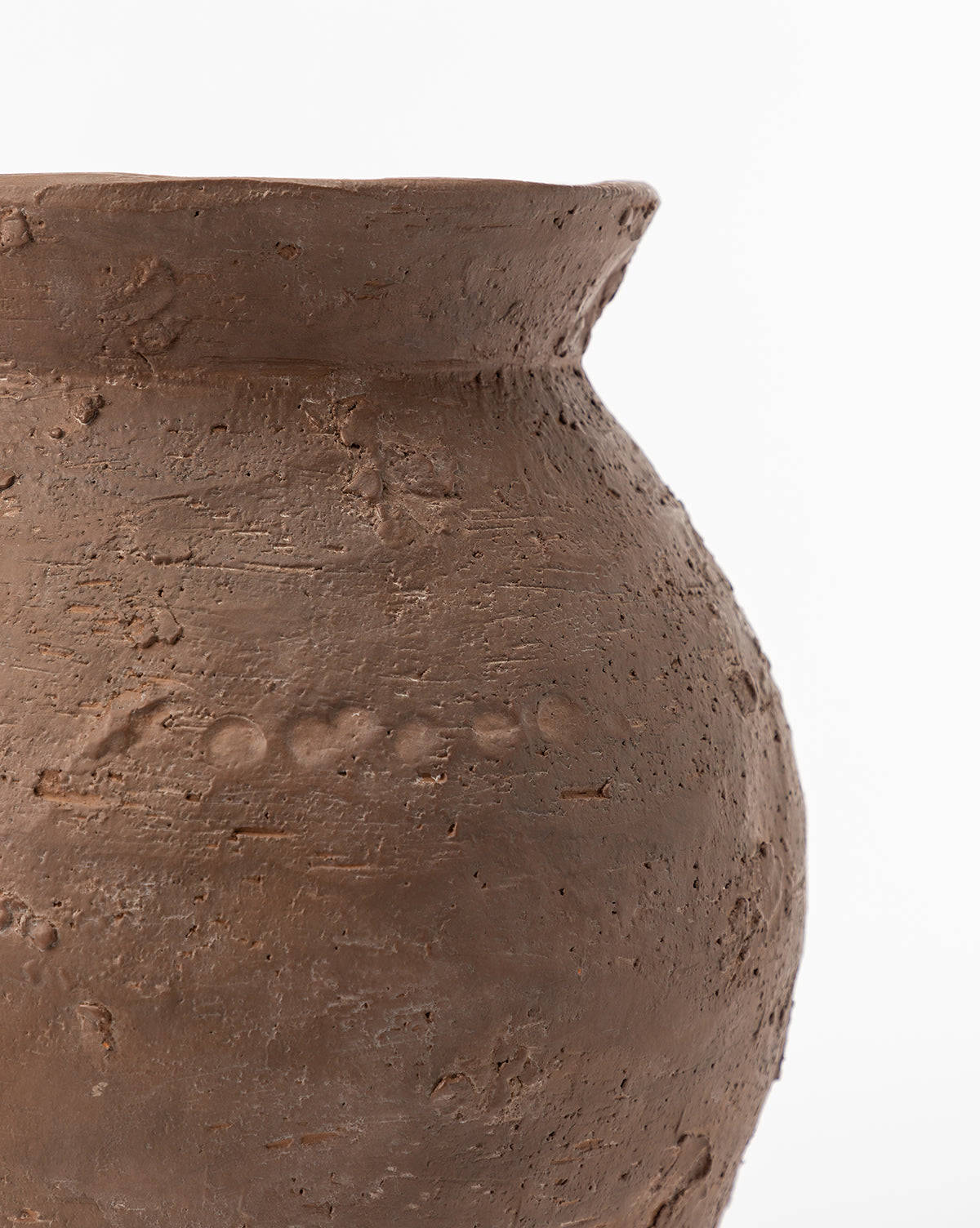 A close-up of the Demetria Terracotta Vase, featuring a rustic, rough-textured surface and a wide, slightly flared rim, set against a plain white background.
