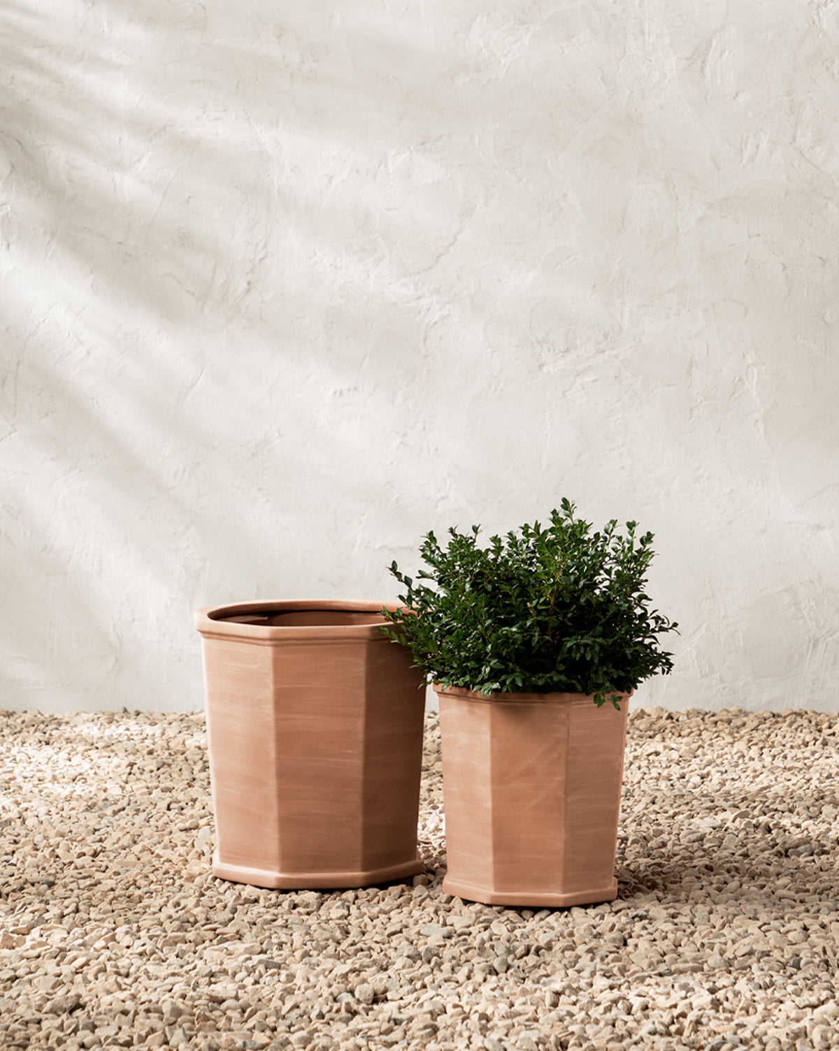 Dempsey Planters in terracotta, styled as a pair in different sizes for outdoor decor, from McGee & Co.