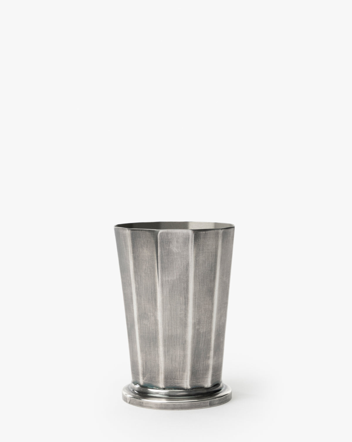 The Derby Vase, featuring a silver finish with fluted vertical ridges and a round base, is ideal for elegant flower arrangements and stands out against a plain white background, by McGee & Co.