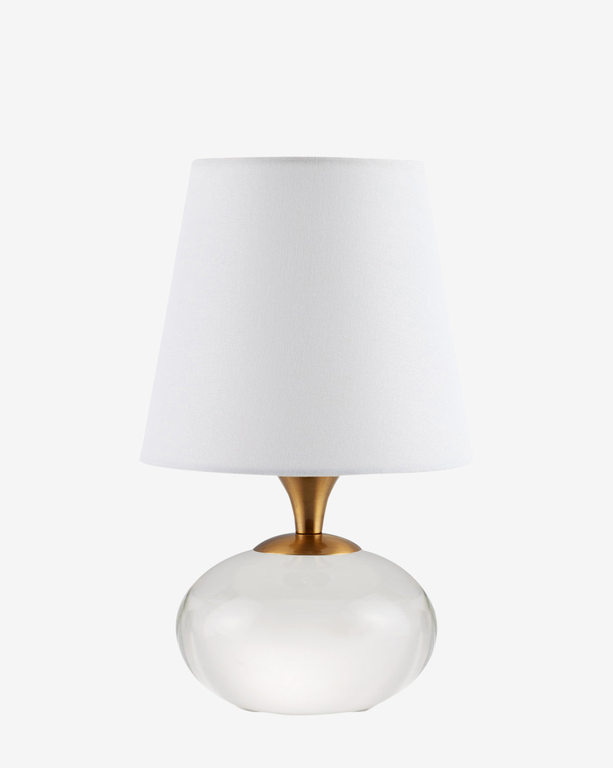 The Currey & Co. Diantha Table Lamp showcases a round clear glass base, gold neck, and white tapered fabric shade, creating a stylish accent against any plain white background. McGee & Co.
