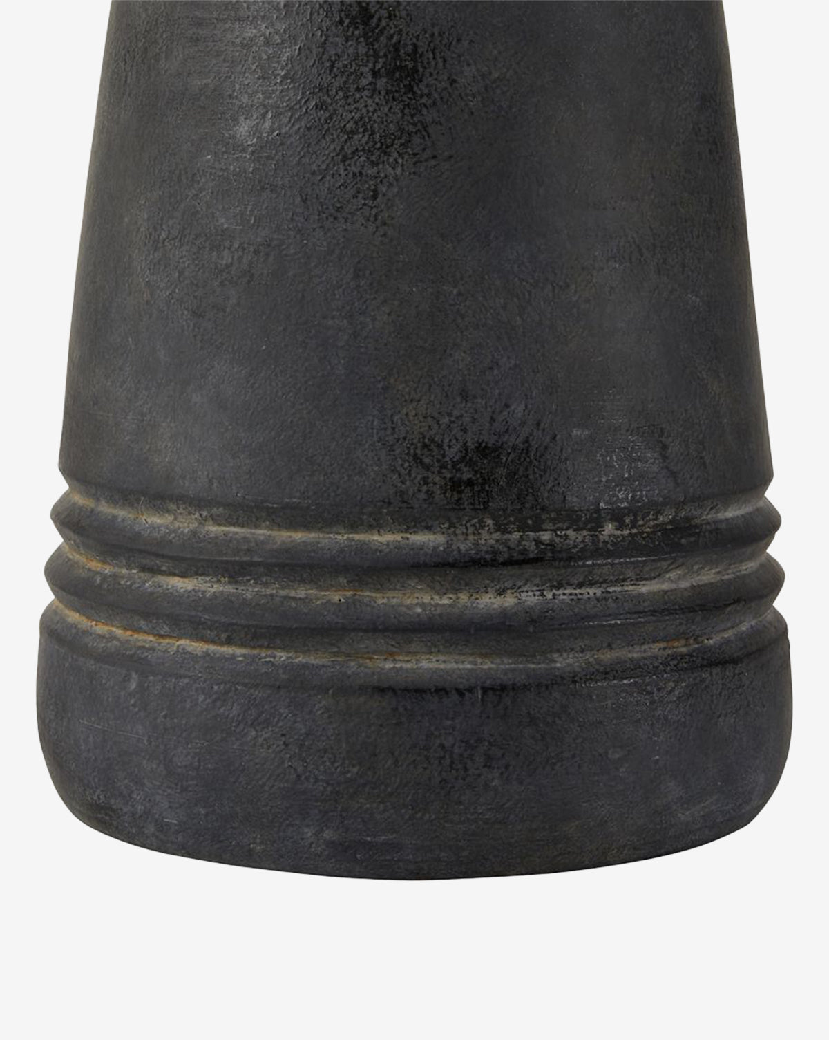 Close-up of the Django Table Lamps textured dark gray base with two horizontal grooves near the bottom, featuring a matte, slightly worn finish that pairs elegantly with its linen shade, by McGee & Co.