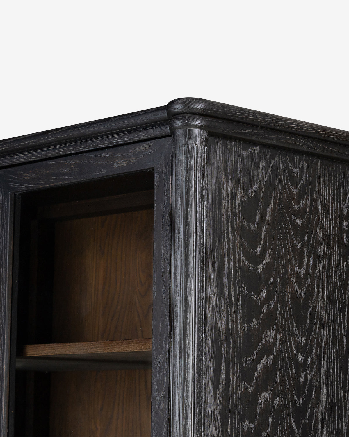 Close-up of the Draven Cabinet’s top corner, showing its wood grain texture and open shelf, set against a plain white background, by McGee & Co.