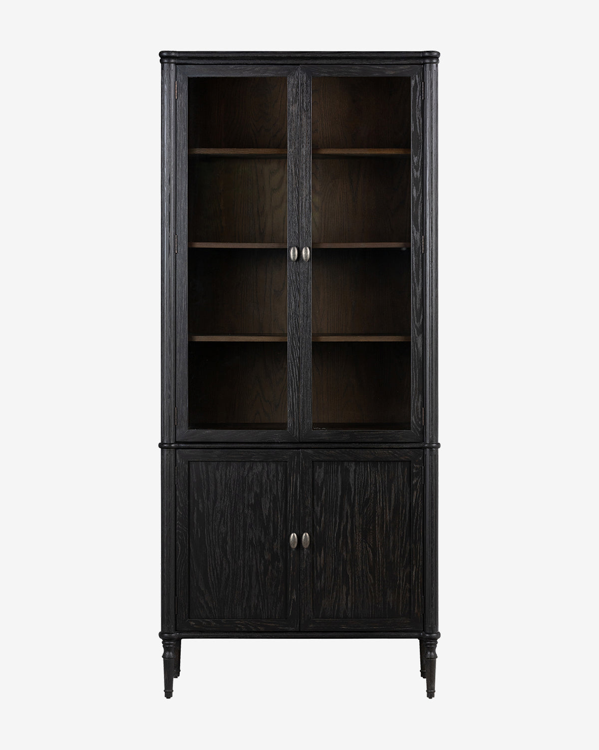 The Draven Cabinet is a tall, dark wood unit with two glass and oak doors above, two solid doors below with silver handles, and three shelves inside for versatile storage by McGee & Co.