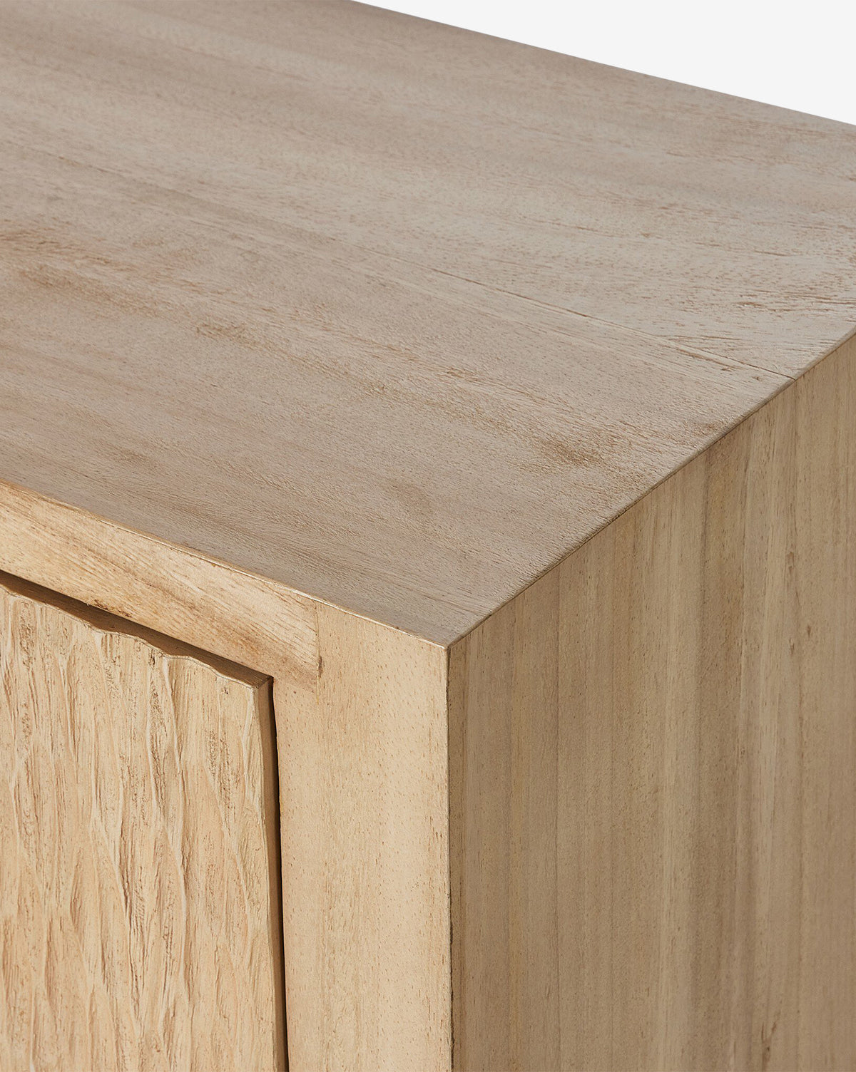 Close-up of the Drayton Sideboard’s corner, showing its smooth light wood surface and textured doors—a stylish addition to your entryway, by McGee & Co.