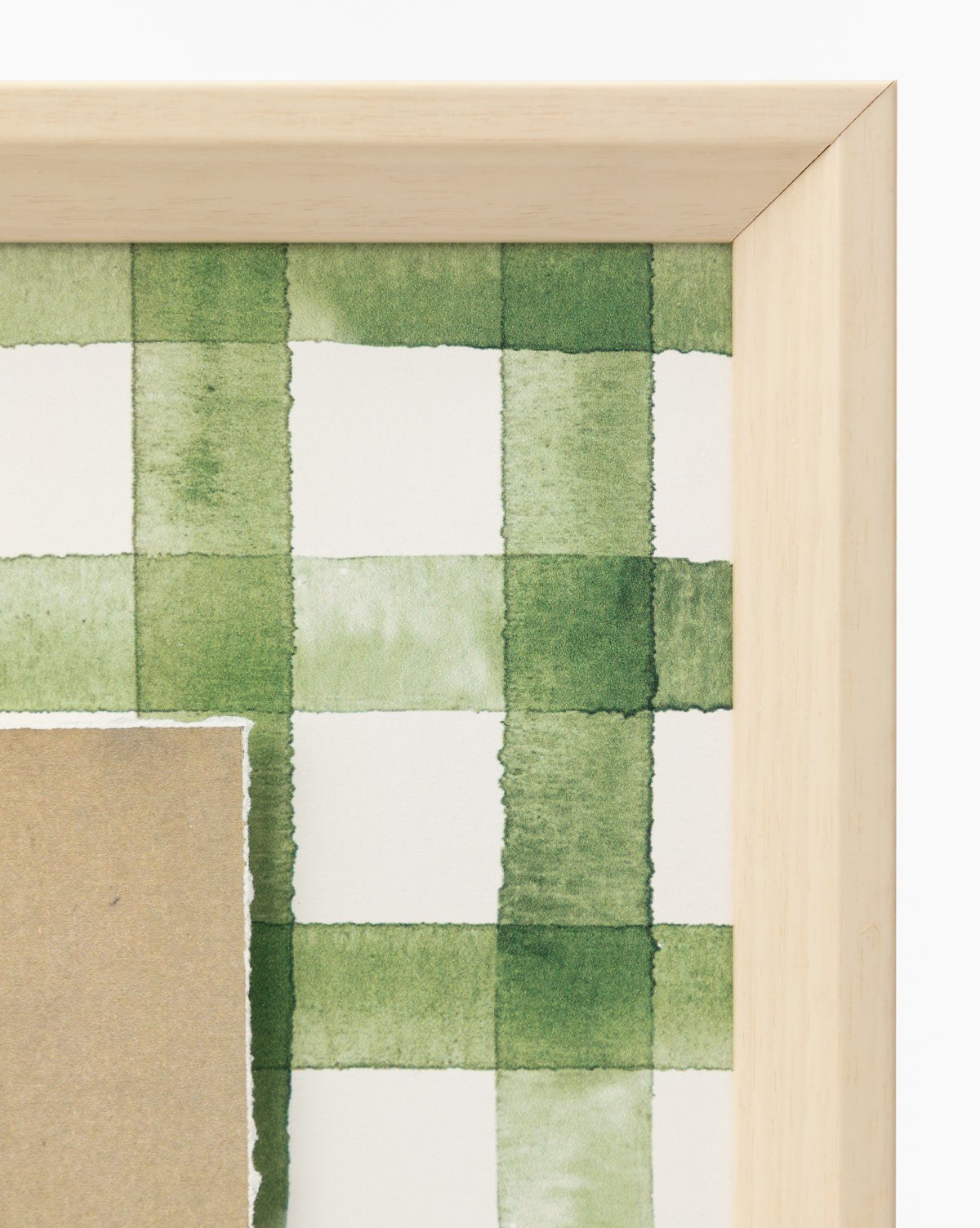 A close-up of the Dreamscape wooden frame corner, showcasing artwork with a green and white checkered watercolor pattern on premium paper and a torn brown overlay—ideal for distinctive home decor, by McGee & Co.