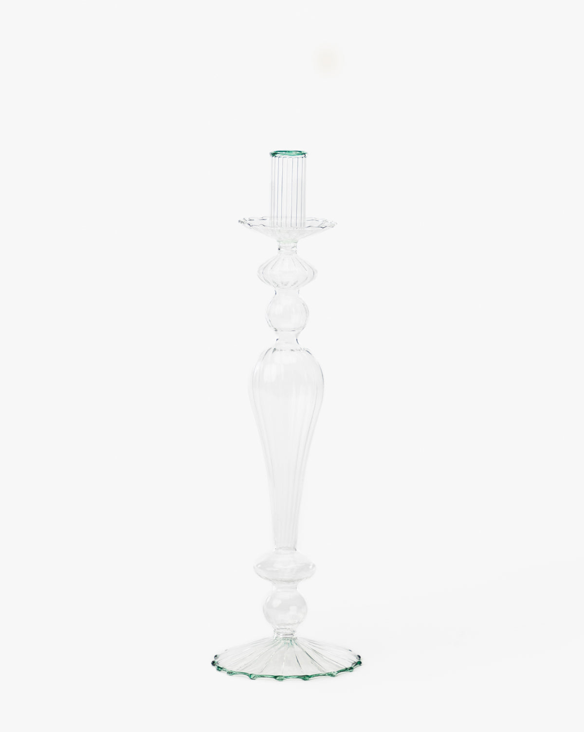 The McGee & Co. x Loeffler Randall Effie Taper Holder is a tall, clear glass holder featuring a fluted design and round base, shown elegantly against a plain white background by McGee & Co.