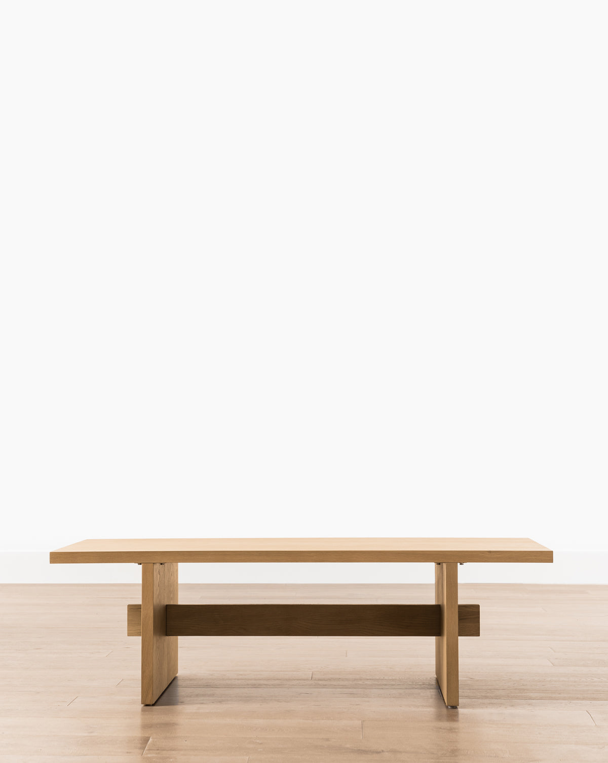The Eileen Coffee Table showcases a minimalist, modern design with clean lines and a rectangular white oak top, ideal for contemporary spaces, by McGee & Co.