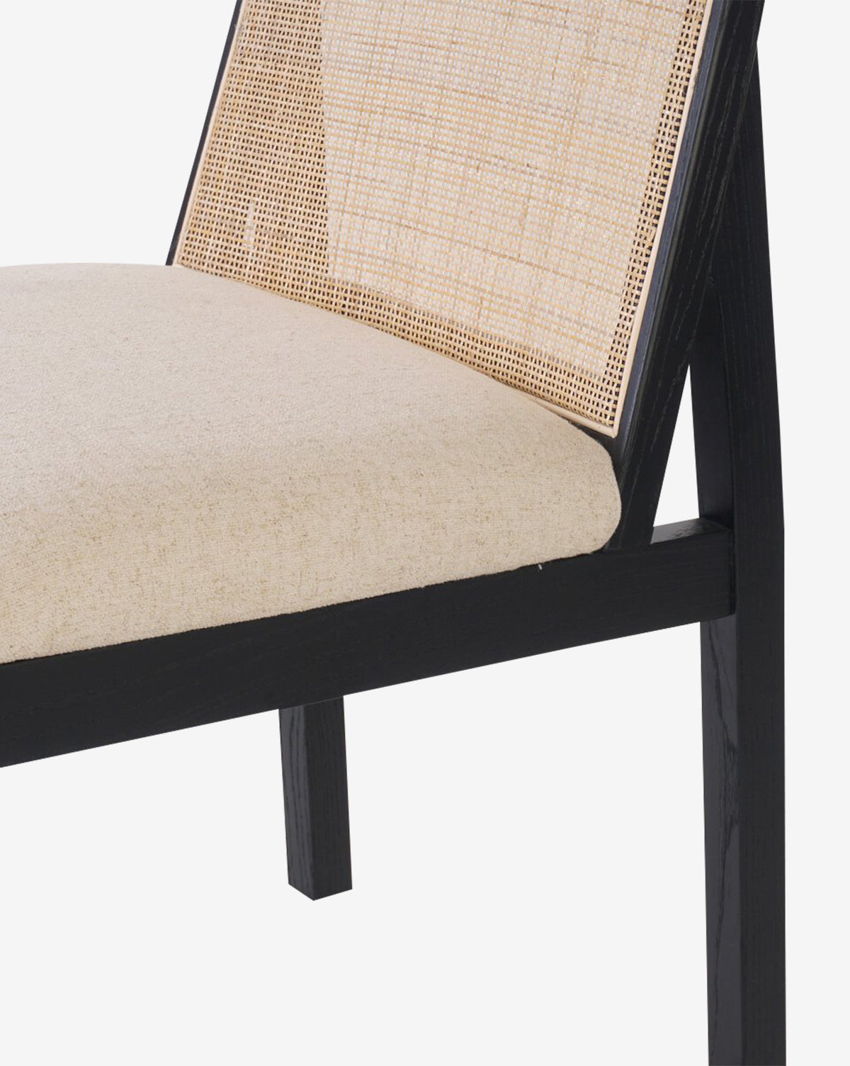 The Eira Dining Chair showcases a black wooden frame, beige performance fabric seat, and an elegant cane back, bringing a modern touch to your dining space, by McGee & Co.