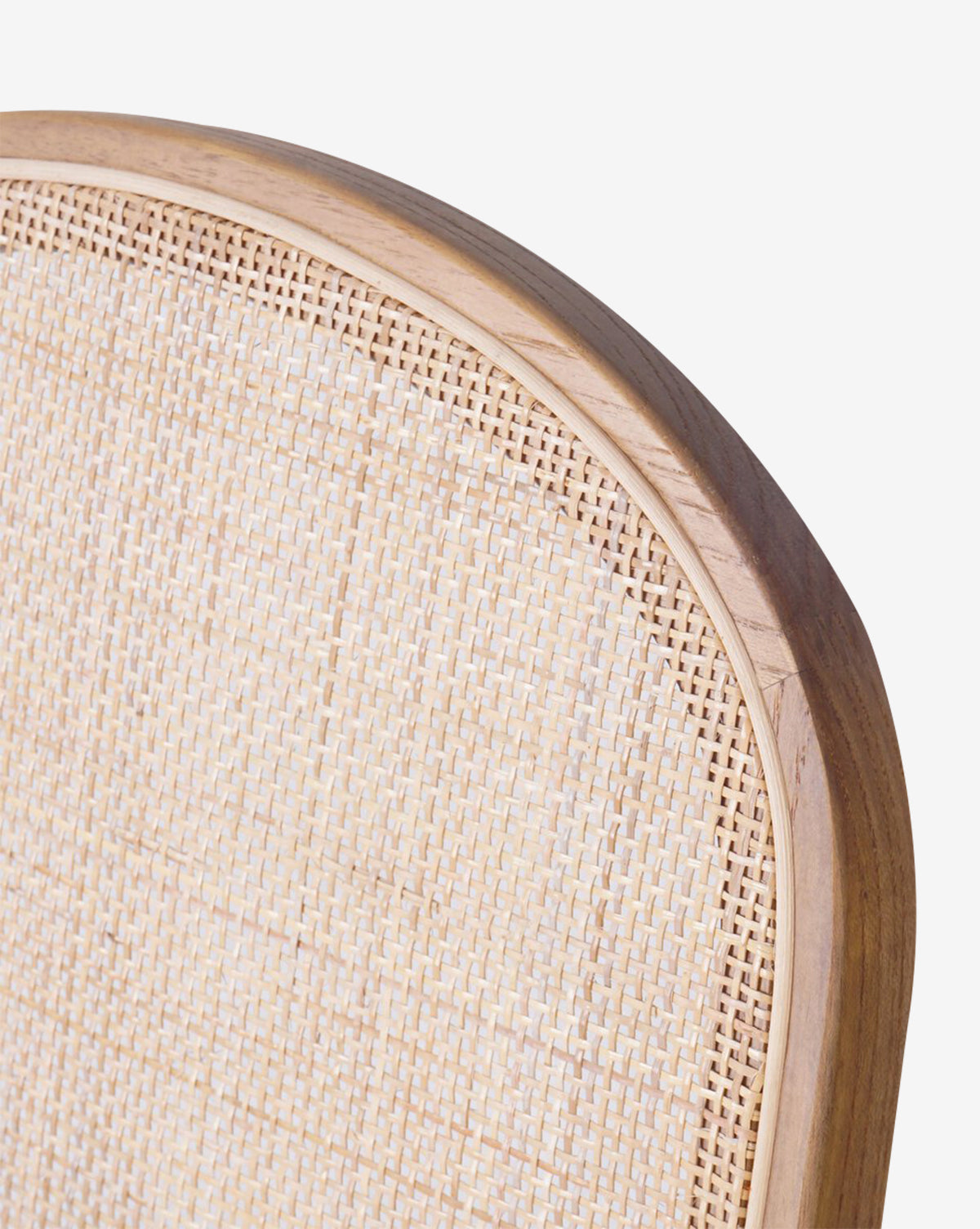 Close-up of the Eira Dining Chair’s upper backrest, showcasing a cane insert in a smooth rounded wooden frame and a performance fabric seat, set against a plain white background by McGee & Co.