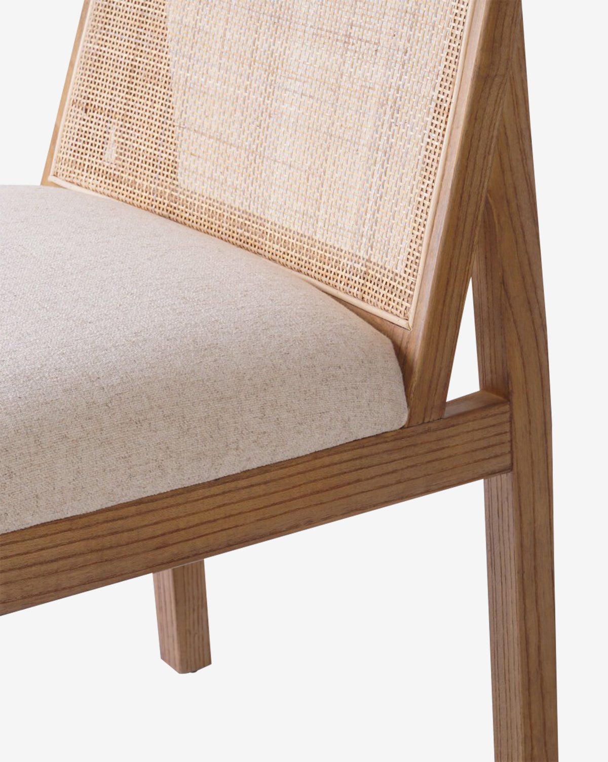 Close-up of the Eira Dining Chair, showcasing a performance fabric seat, woven cane back, and a sleek, minimalist design by McGee & Co.