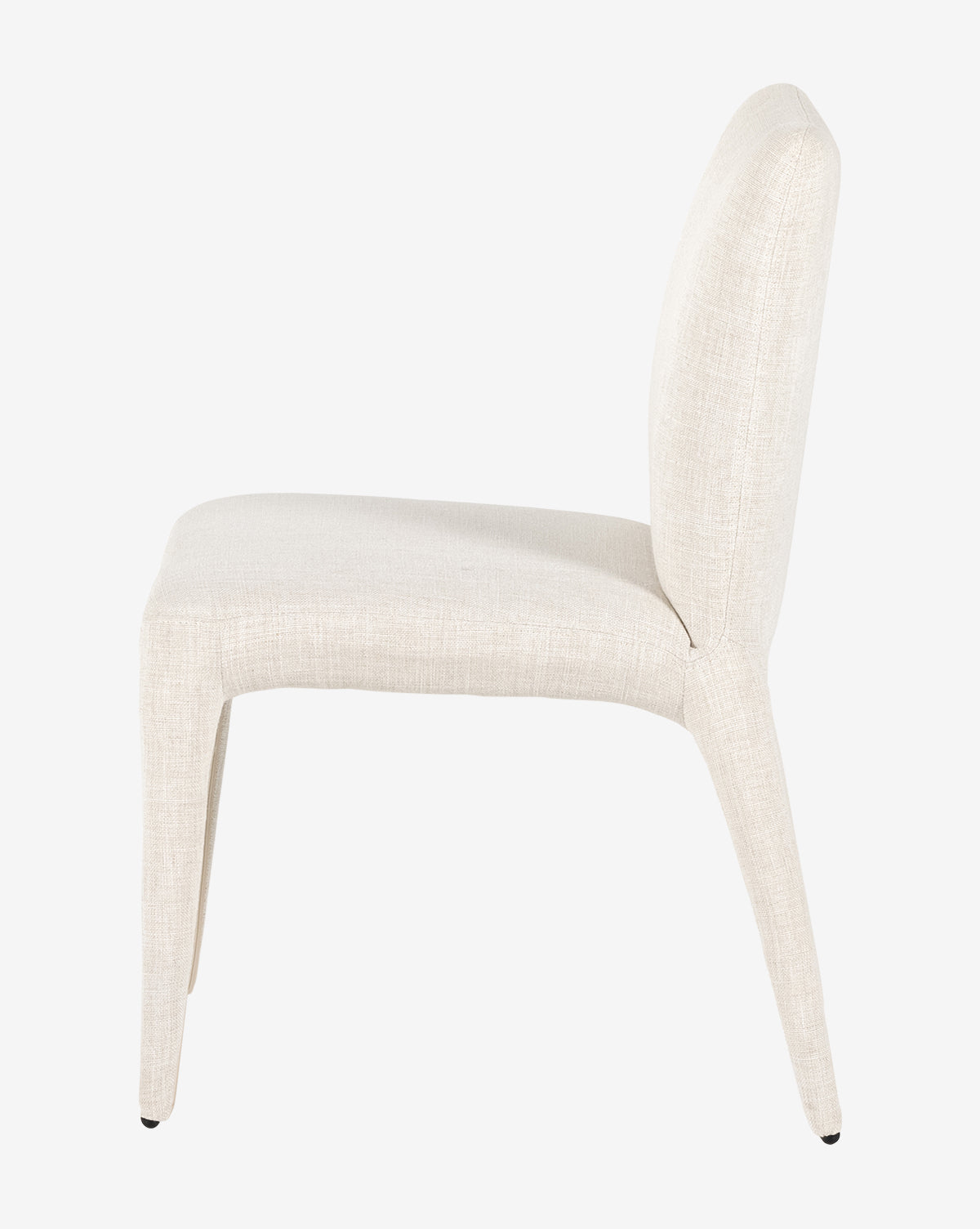 Side view of the Elbert Dining Chair, upholstered in light beige flax linen with a gently curved backrest and tapered legs, shown against a plain white background, by McGee & Co.