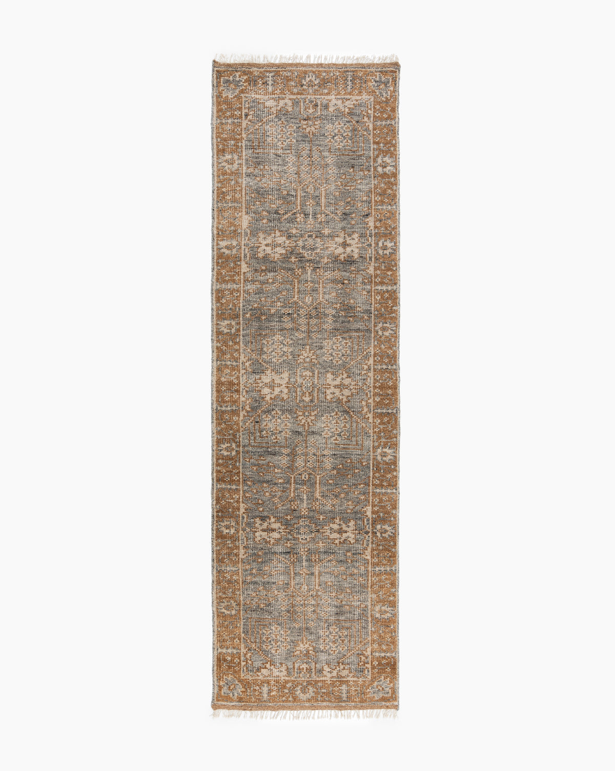 The Elison Hand-Knotted Wool Rug features a distressed vintage pattern in muted blue, beige, and brown with a detailed border and fringed edges on the short sides, inspired by traditional textiles, by McGee & Co.