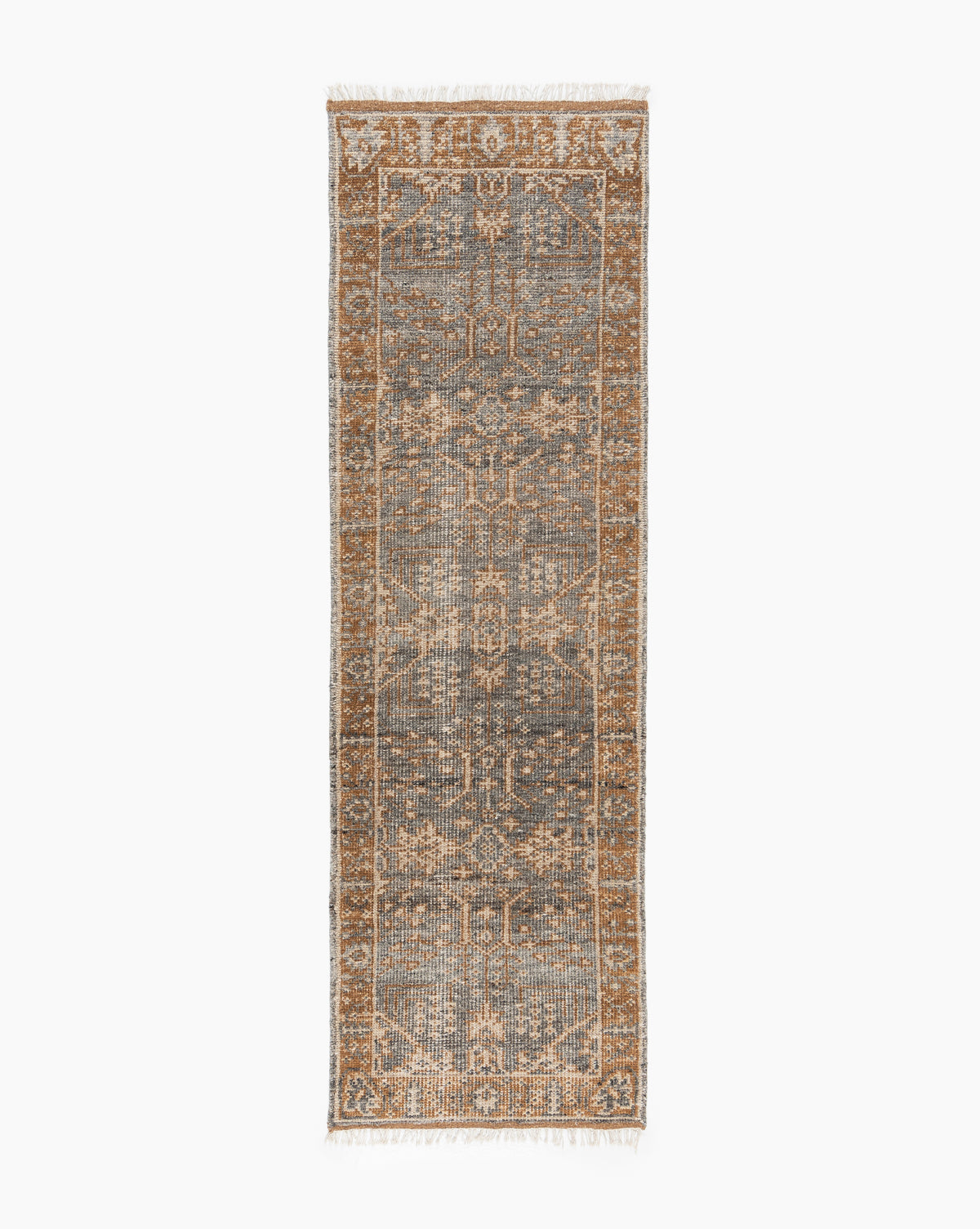 The Elison Hand-Knotted Wool Rug is a rectangular runner with a distressed vintage pattern in muted blue and brown, highlighted by a central geometric design, artisan-inspired details, and fringed edges for unique character, by McGee & Co.