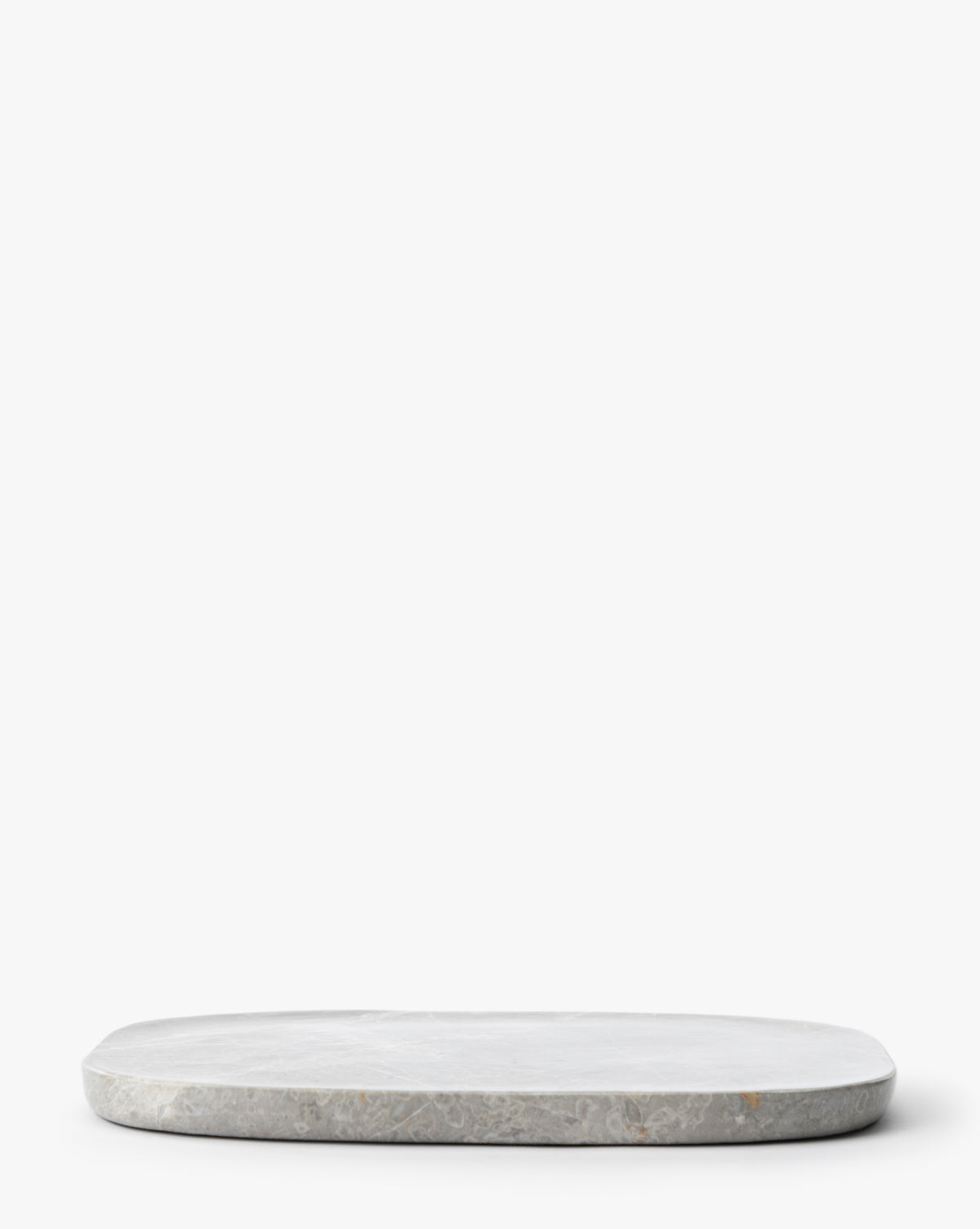 The Eliza Marble Tray, a round and flat gray marble tray, is placed on a white background with empty space above, by McGee & Co.