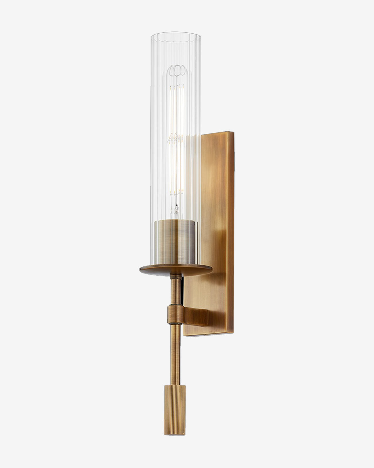 The Elton Sconce by Troy Lighting features a patina brass finish, cylindrical fluted glass shade, vertical rectangular backplate, and exposed bulb for a modern look. McGee & Co.